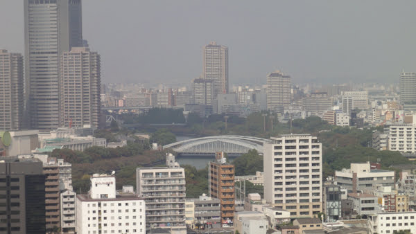 a zoomed-in view of city buildings and a bridge